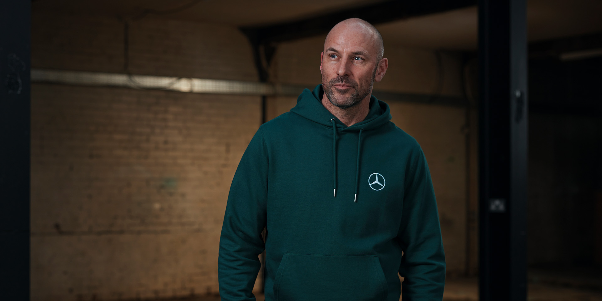 Women wearing green polo shirt and man wearing black polo shirt