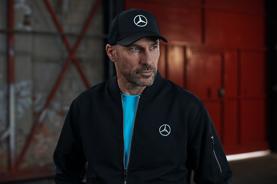 Man wearing black mercedes-benz branded clothing
