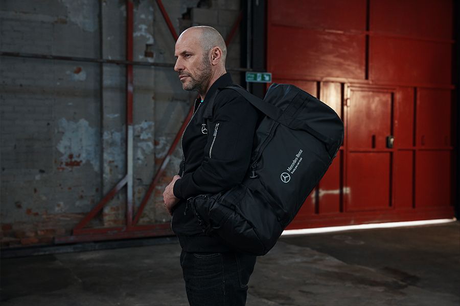 Man holding mercedes-benz branded bag
